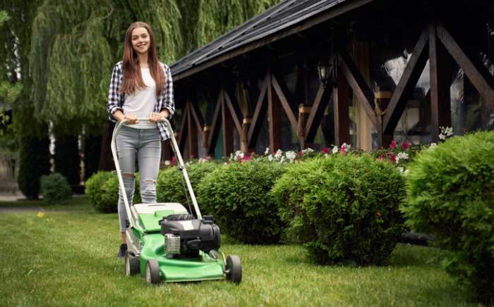 female gardener using lawn mower picture id1206022550 1
