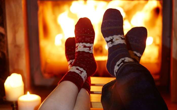 man and woman in warm socks near fireplace picture id856335508 1
