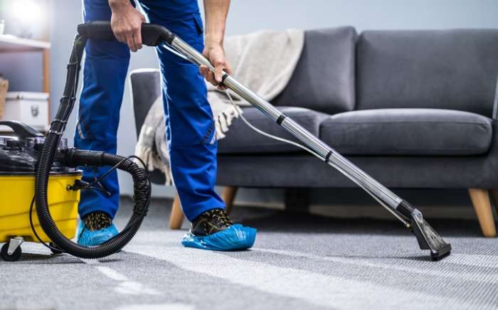 person cleaning carpet with vacuum cleaner picture id1191080465 1