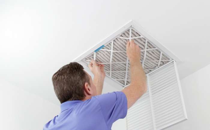 person removing ceiling air filter picture id962695538 1