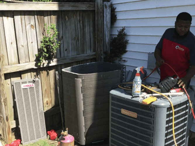 Reliability home services technician working on HVAc unit