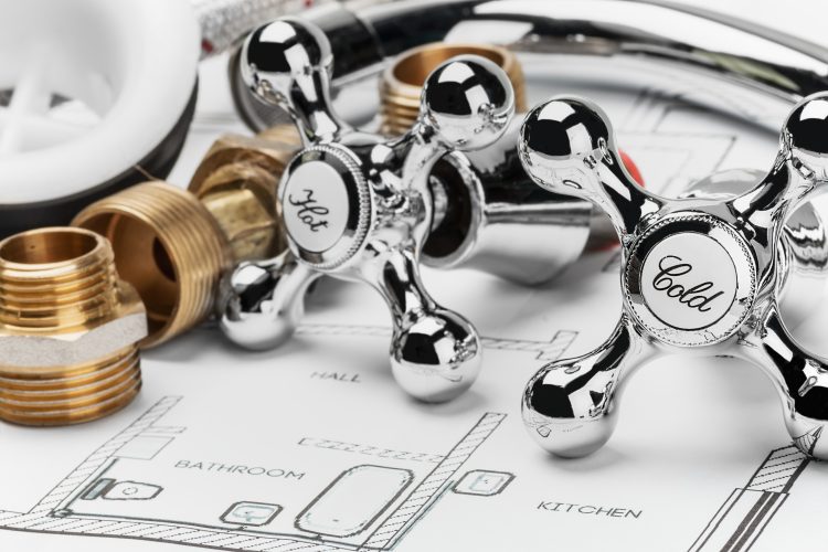 plumbing and tools lying on drawing for repair. Focus on the word cold